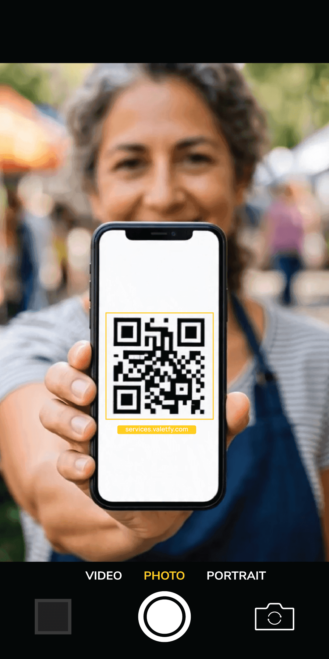 Customer scanning a Valetfy service terminal QR code